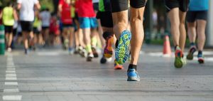 Marathon running race, people feet on city road